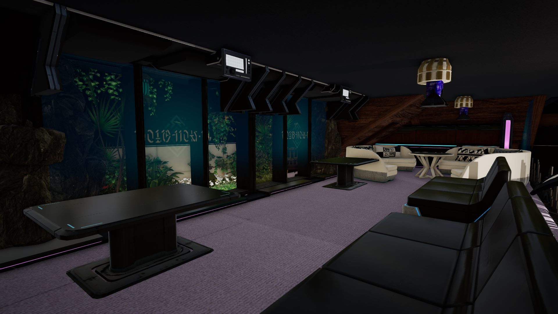 A row of tall planted windows along one wall of the upstairs lounge, monitor arms mounted overhead on a rail, dark tables on lavender carpet, and cream corner couches around a low round table.