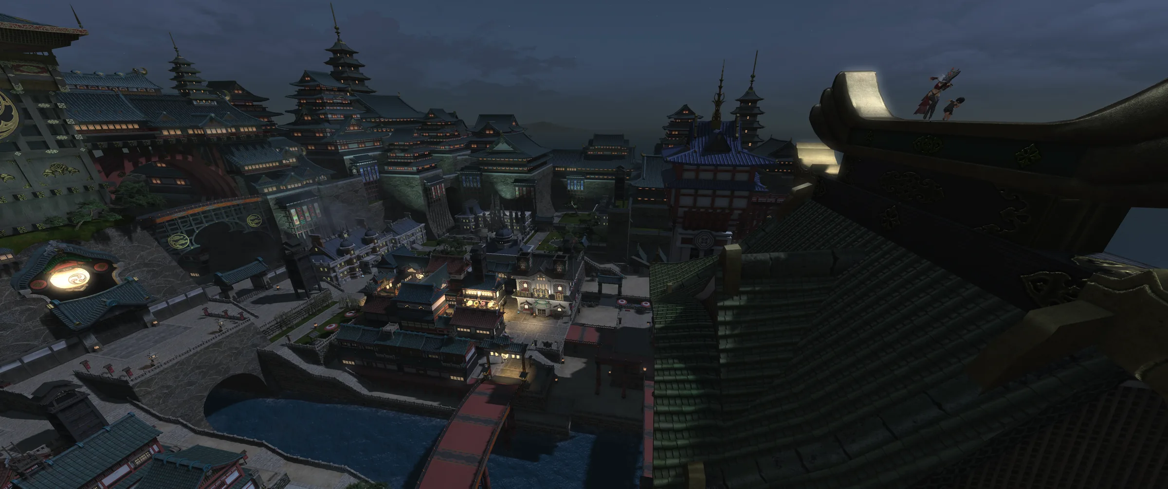 Kugane's rooftops at dusk seen from high on the tower: tiered pagodas and lantern-lit streets running down to the harbour, the sea flat and pale behind them, and two tiny figures standing on a curved roof ridge at the right.
